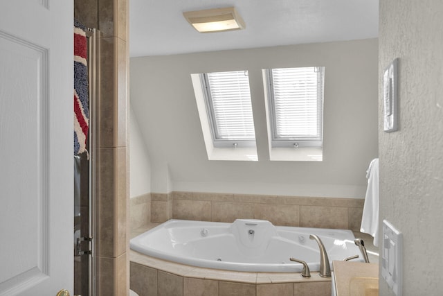 bathroom featuring shower with separate bathtub