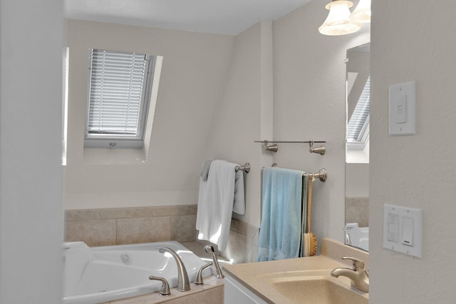 bathroom featuring a washtub and vanity