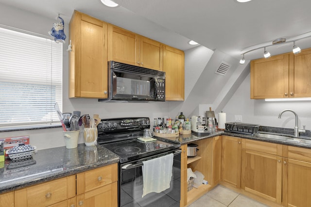 kitchen featuring sink, light tile patterned floors, dark stone countertops, track lighting, and black appliances