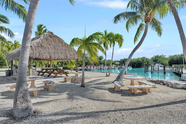 surrounding community featuring a gazebo and a water view