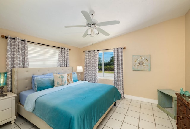 bedroom with vaulted ceiling, light tile patterned floors, and ceiling fan