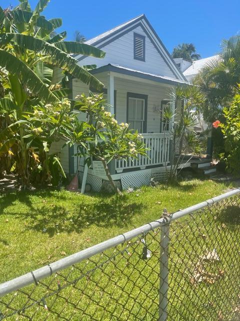 exterior space featuring covered porch and a lawn