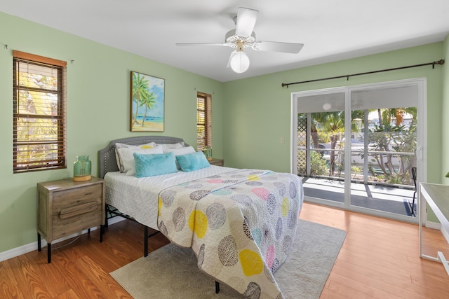 bedroom featuring access to exterior, hardwood / wood-style floors, and ceiling fan