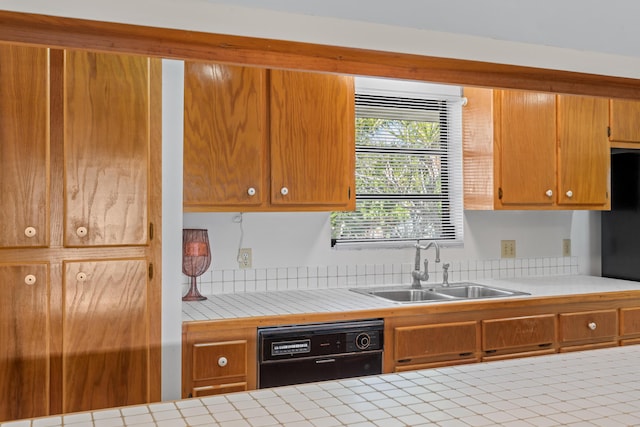 kitchen featuring sink, tile counters, and black appliances