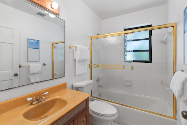 full bathroom featuring vanity, bath / shower combo with glass door, and toilet