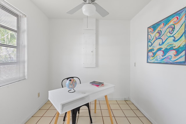 tiled home office featuring electric panel and ceiling fan