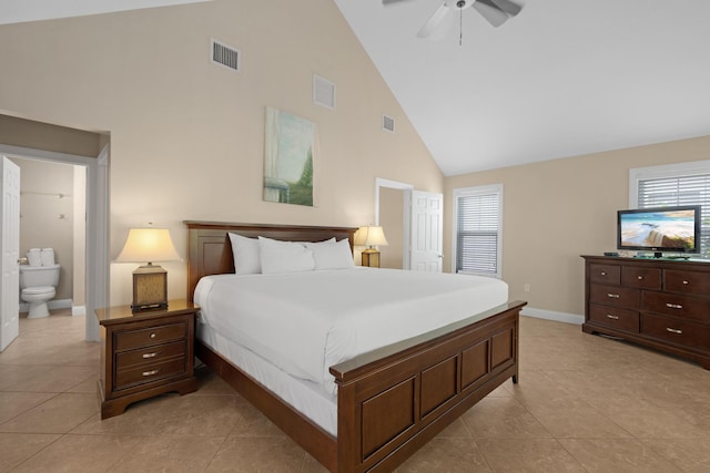 tiled bedroom with multiple windows, ceiling fan, high vaulted ceiling, and ensuite bath