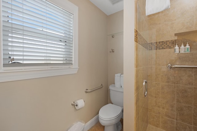 bathroom featuring toilet and a shower with shower door