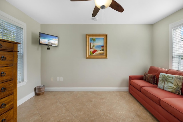 living area featuring ceiling fan and light tile patterned floors