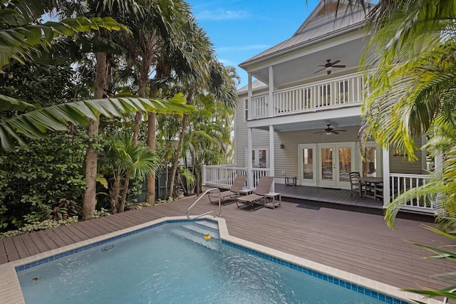 back of house with a pool side deck, a balcony, french doors, and ceiling fan