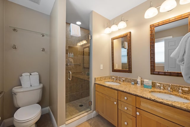 bathroom featuring an enclosed shower, vanity, and toilet