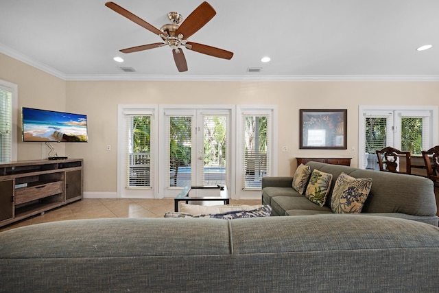 tiled living room with ornamental molding and plenty of natural light