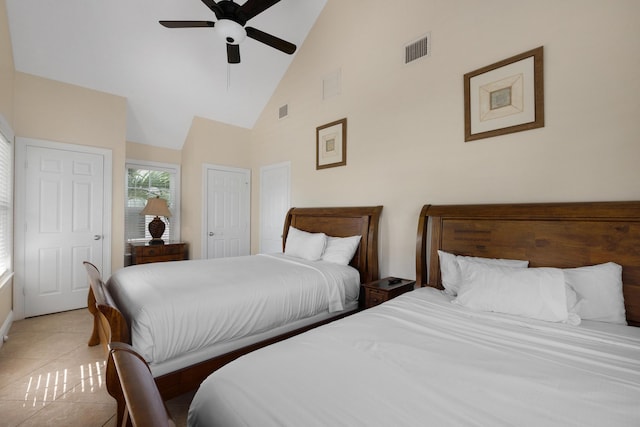 bedroom with ceiling fan, high vaulted ceiling, and light tile patterned floors