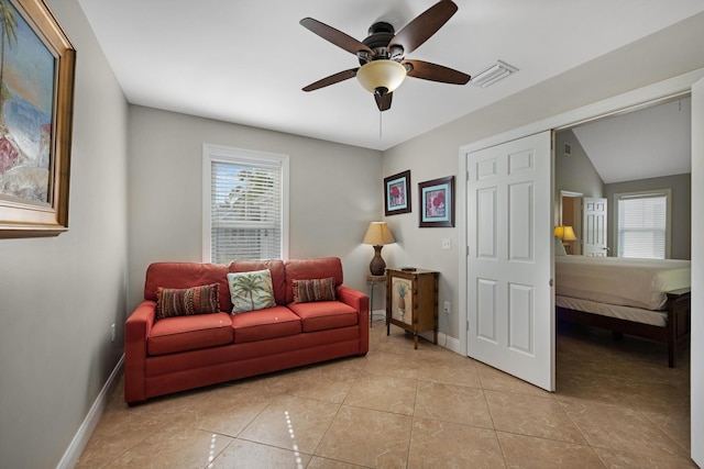 tiled living room featuring ceiling fan