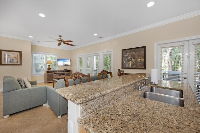 kitchen featuring french doors, ornamental molding, kitchen peninsula, and sink