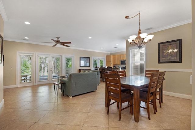 tiled dining room featuring crown molding and ceiling fan with notable chandelier