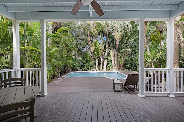 view of swimming pool featuring ceiling fan and a deck