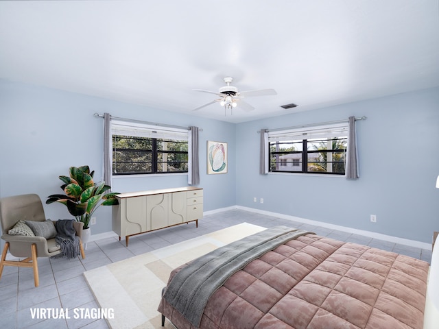 bedroom featuring light tile patterned flooring, visible vents, baseboards, and ceiling fan