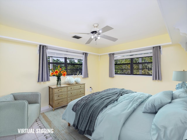 bedroom featuring baseboards, visible vents, and ceiling fan