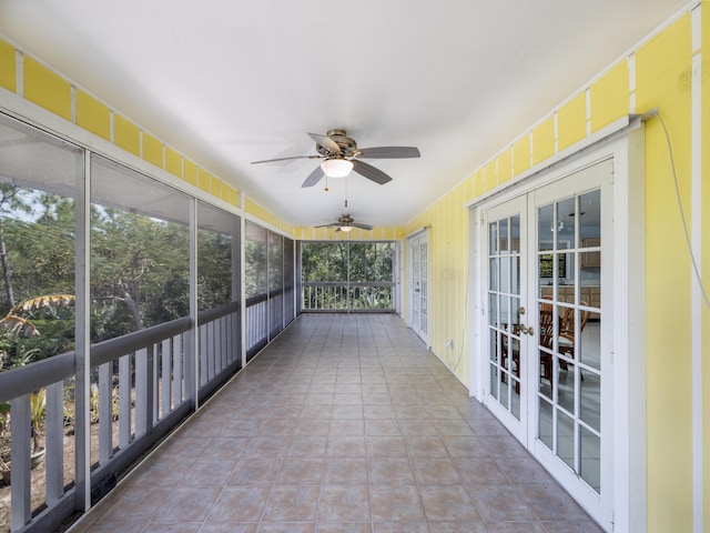 unfurnished sunroom featuring french doors and a ceiling fan