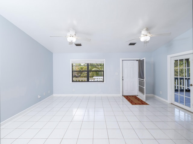 empty room featuring light tile patterned flooring, visible vents, baseboards, and ceiling fan