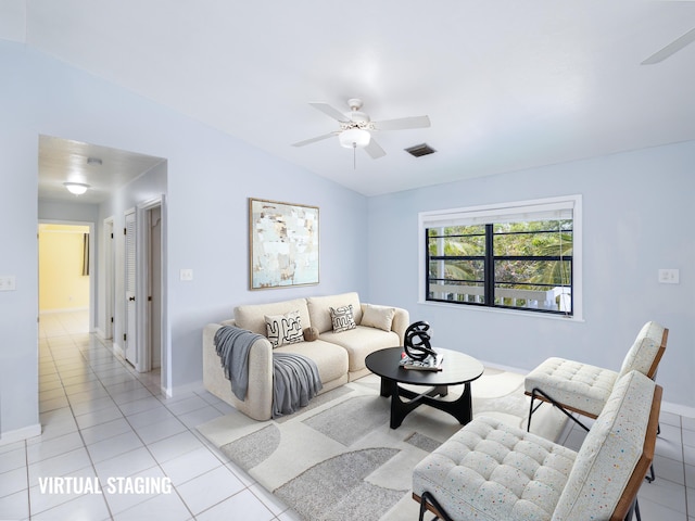 living area with lofted ceiling, light tile patterned flooring, and ceiling fan