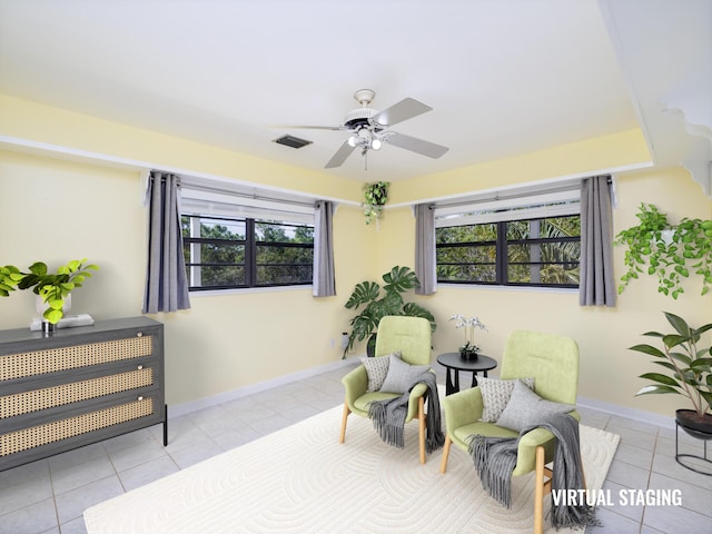 sitting room featuring tile patterned flooring, plenty of natural light, a ceiling fan, and visible vents