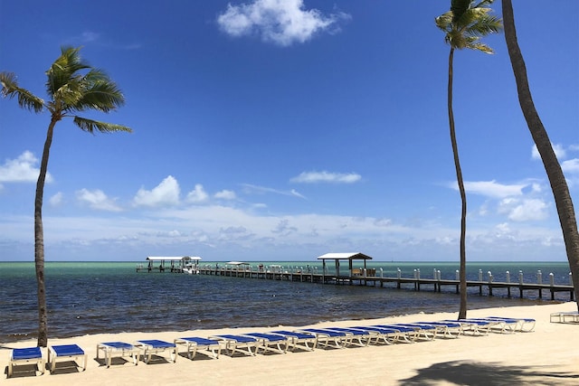 view of property's community featuring a beach view and a water view