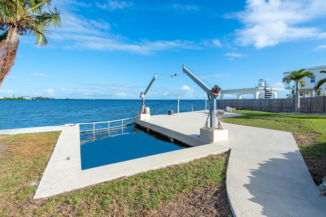 dock area with a yard and a water view