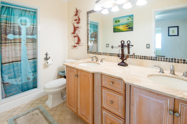 bathroom featuring tile patterned flooring, vanity, a shower with shower curtain, and toilet