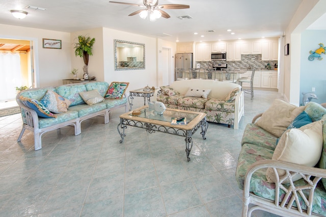 tiled living room with ceiling fan