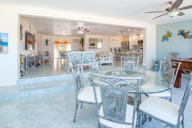 tiled dining space featuring ceiling fan