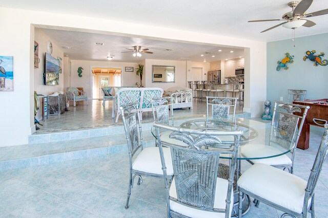 tiled dining area with ceiling fan