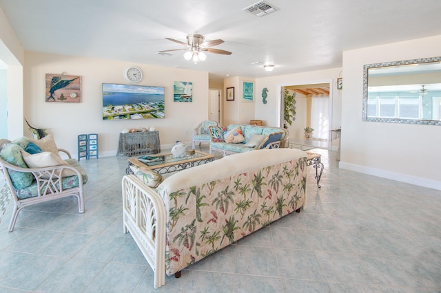 living room featuring light tile patterned floors and ceiling fan