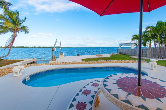 view of pool with a water view