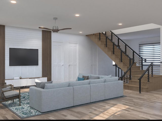 living room with ceiling fan and light wood-type flooring