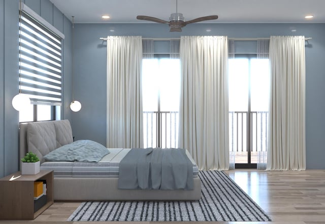 bedroom with multiple windows and light wood-type flooring