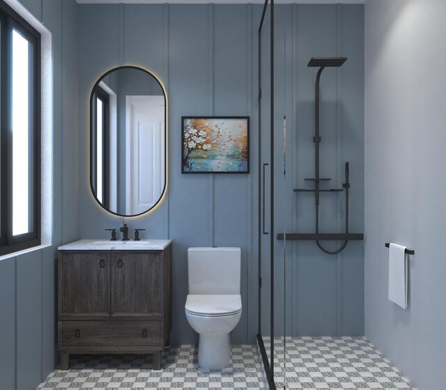 bathroom with vanity, a shower, and toilet