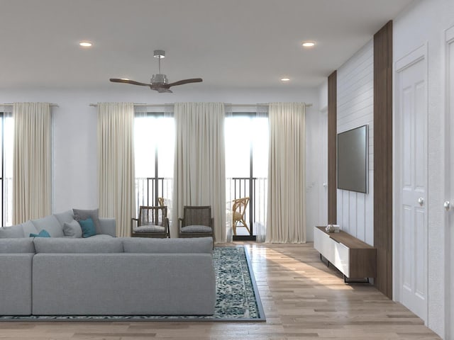 living room featuring ceiling fan and light hardwood / wood-style floors