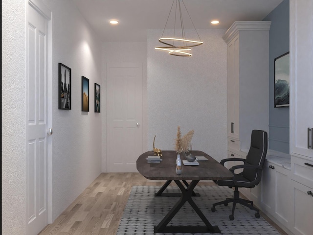 home office with light hardwood / wood-style flooring