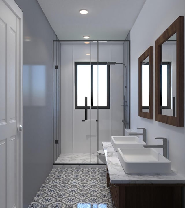 bathroom with tile patterned floors, vanity, toilet, and a shower with door