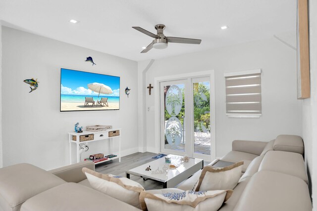 living room with wood-type flooring and ceiling fan