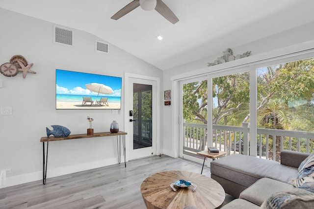 living room with ceiling fan, lofted ceiling, and light hardwood / wood-style floors