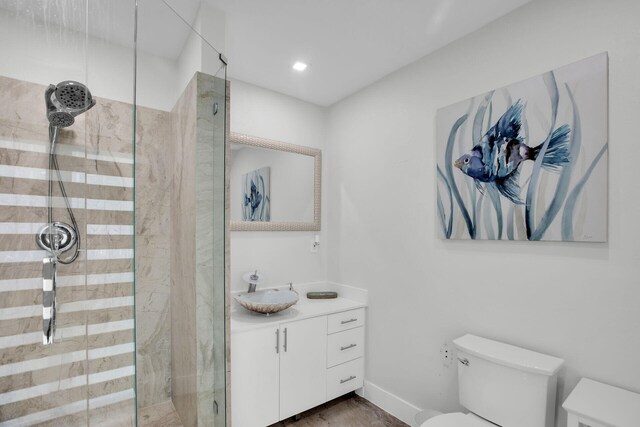 bathroom with vanity, toilet, and an enclosed shower