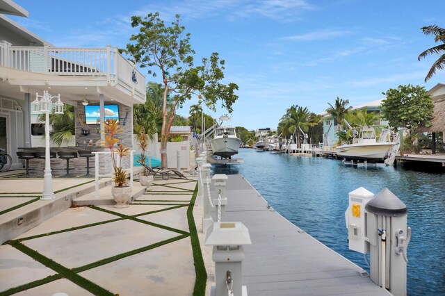 dock area featuring a balcony and a water view