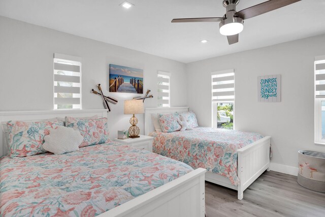 bedroom featuring light hardwood / wood-style floors and ceiling fan