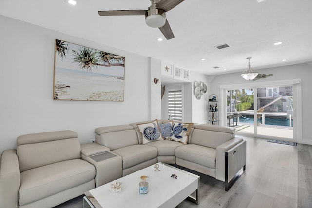 living room featuring ceiling fan and light hardwood / wood-style flooring