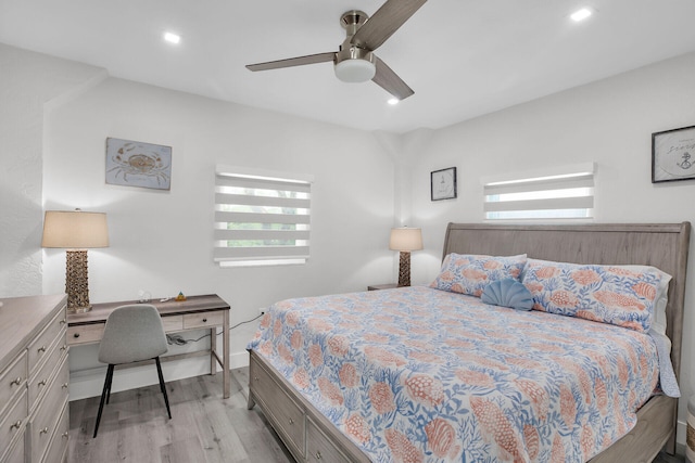 bedroom featuring multiple windows, ceiling fan, and light wood-type flooring