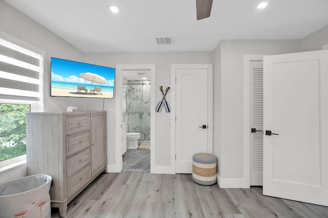 bathroom with an enclosed shower, hardwood / wood-style floors, toilet, and ceiling fan