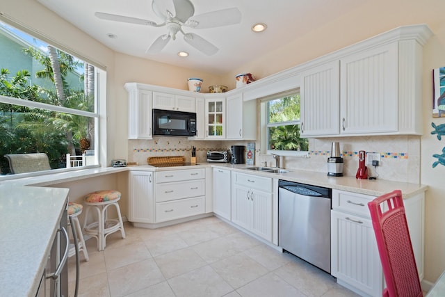 kitchen featuring sink, stainless steel dishwasher, and white cabinets